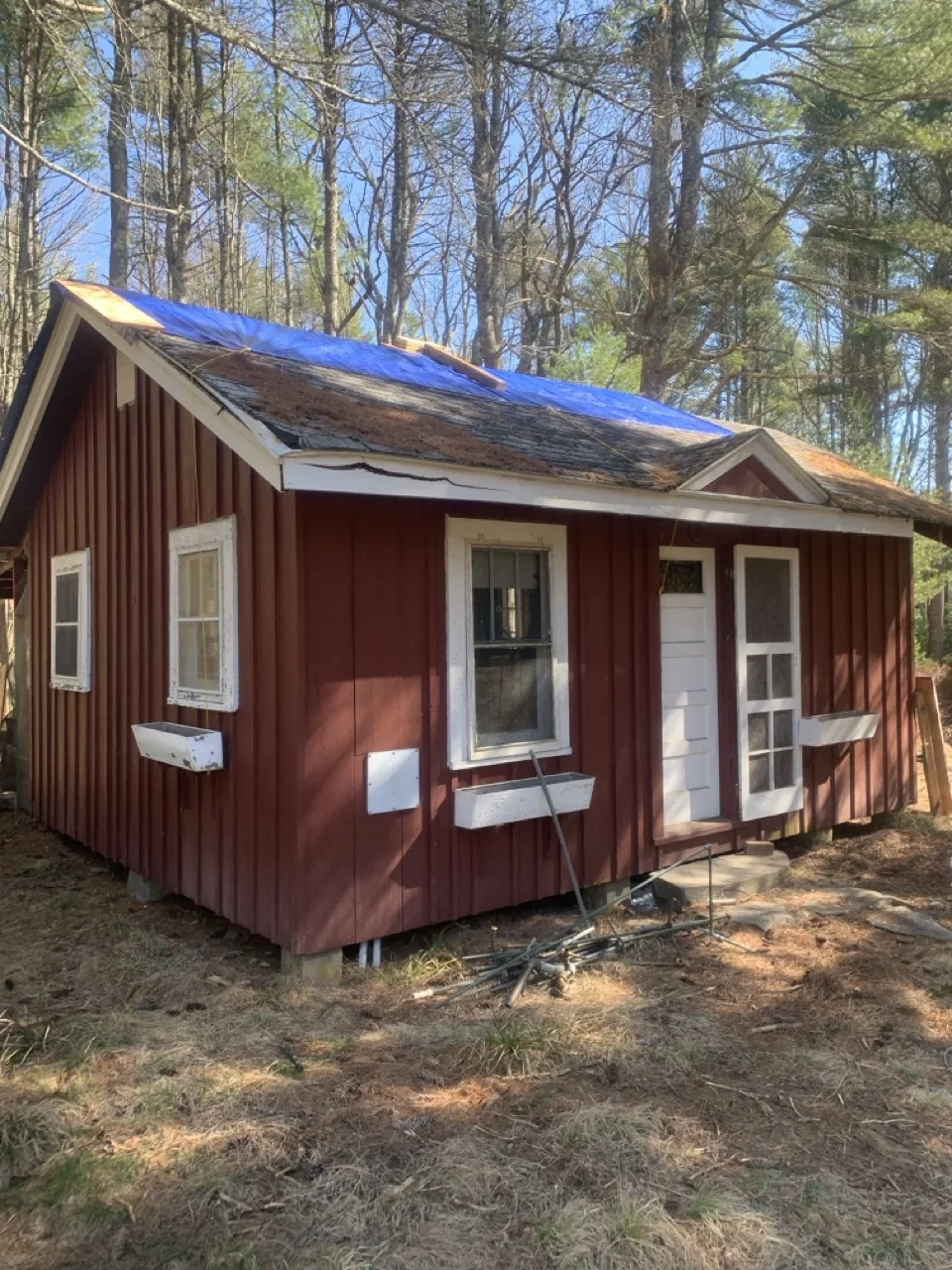 Small red cabin before major roof and interior restoration
