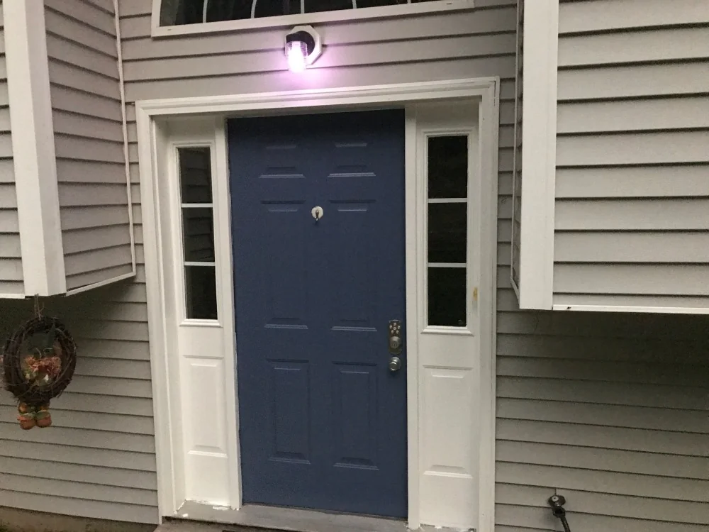 Refreshed exterior entry with a painted blue door and white trim