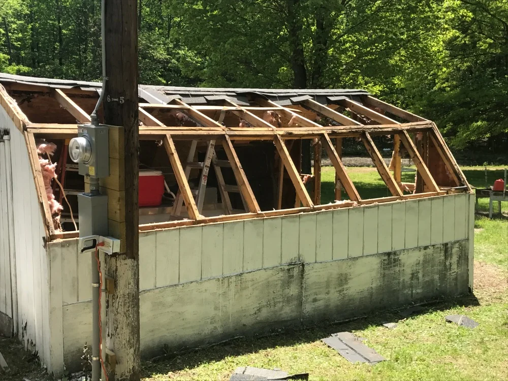 Backyard outbuilding partially dismantled during removal